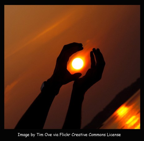 Reaching hands and sun via Flickr by timove with frame and caption