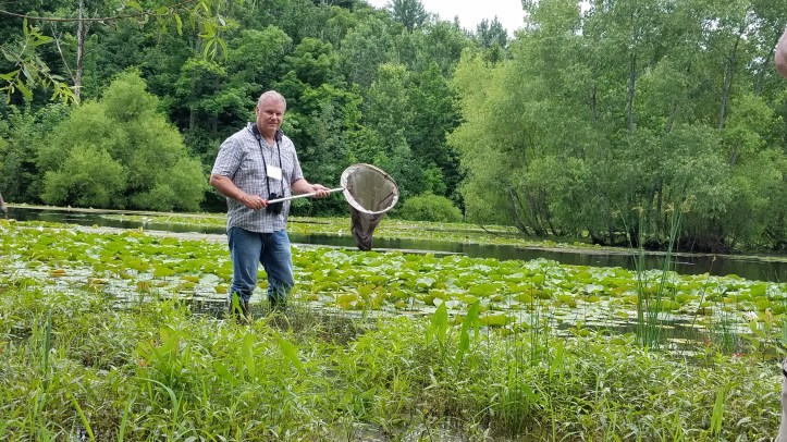 Jim McCormac with net in pond